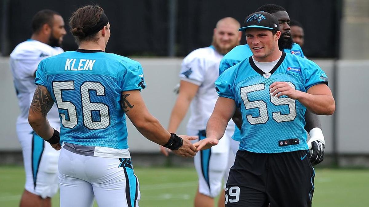 
Carolina Panthers linebackers A.J. Klein, left, slaps hands with Luke Kuechly, right, as they prepare to begin stretching during practice on Wednesday, September 16, 2015. Kuechly suffered a concussion in the team's season opener on Sunday vs the Jacksonville Jaguars.
