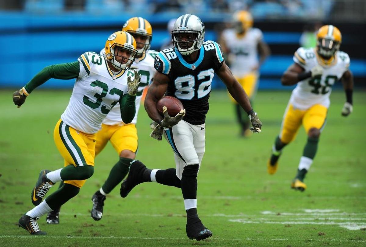 Carolina Panthers wide receiver Jerricho Cotchery, center, runs for extra yardage following a pass reception from quarterback Cam Newton against the Packers in November.