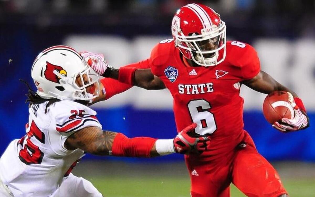 NC State Wolfpack wide receiver T.J. Graham (6) pushes Louisville Cardinals defensive back Anthony Branch (25) following a pass reception during second quarter action in the Belk Bowl at Bank of America Stadium in Charlotte, NC on Tuesday, December 27, 2011. Graham was signed by the Carolina Panthers on Monday, July 24, on the even of the team’s 2017 training camp in Spartanburg. Jeff Siner - jsiner@charlotteobserver.com