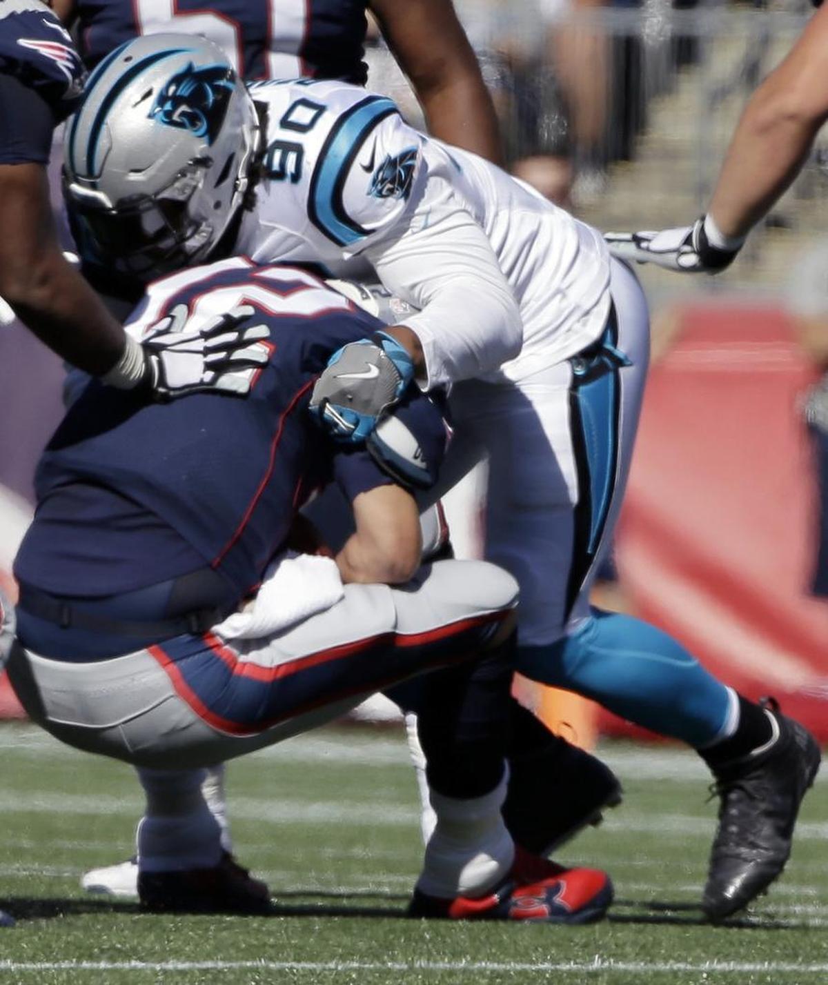 Carolina Panthers defensive end Julius Peppers (90) says he doesn’t think about it now, but that one day it’ll be nice to remember he sacked guys such as New England Patriots quarterback Tom Brady (12).