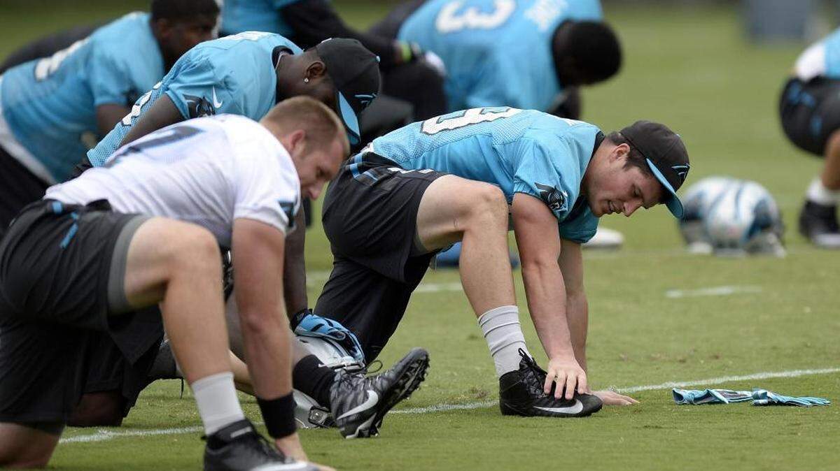 
Carolina Panthers linebacker Luke Kuechly stretches with the team before practice on Thursday. Kuechly is still limited to non-contact drills as he recovers from a concussion.
