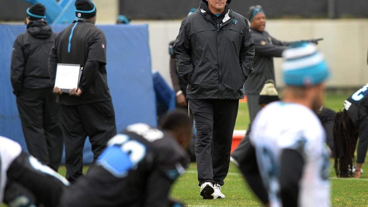 Carolina Panthers head coach Ron Rivera, center, watches the players stretch during practice on Tuesday.
