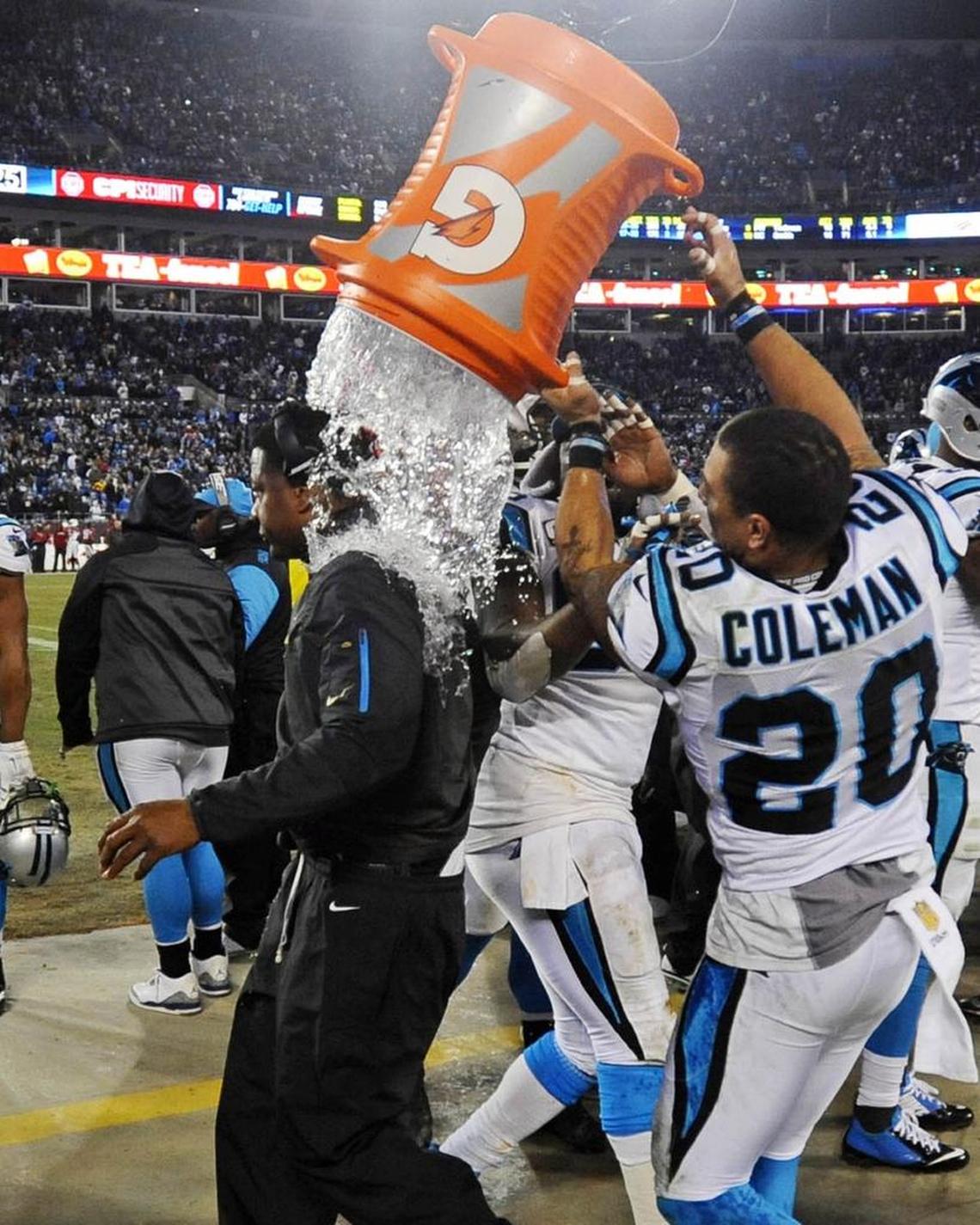 Carolina Panthers free safety Kurt Coleman (20) helps douse assistant head coach/coach Steve Wilks while celebrating the team’s impending victory over the Arizona Cardinals in the NFC Championship Game.