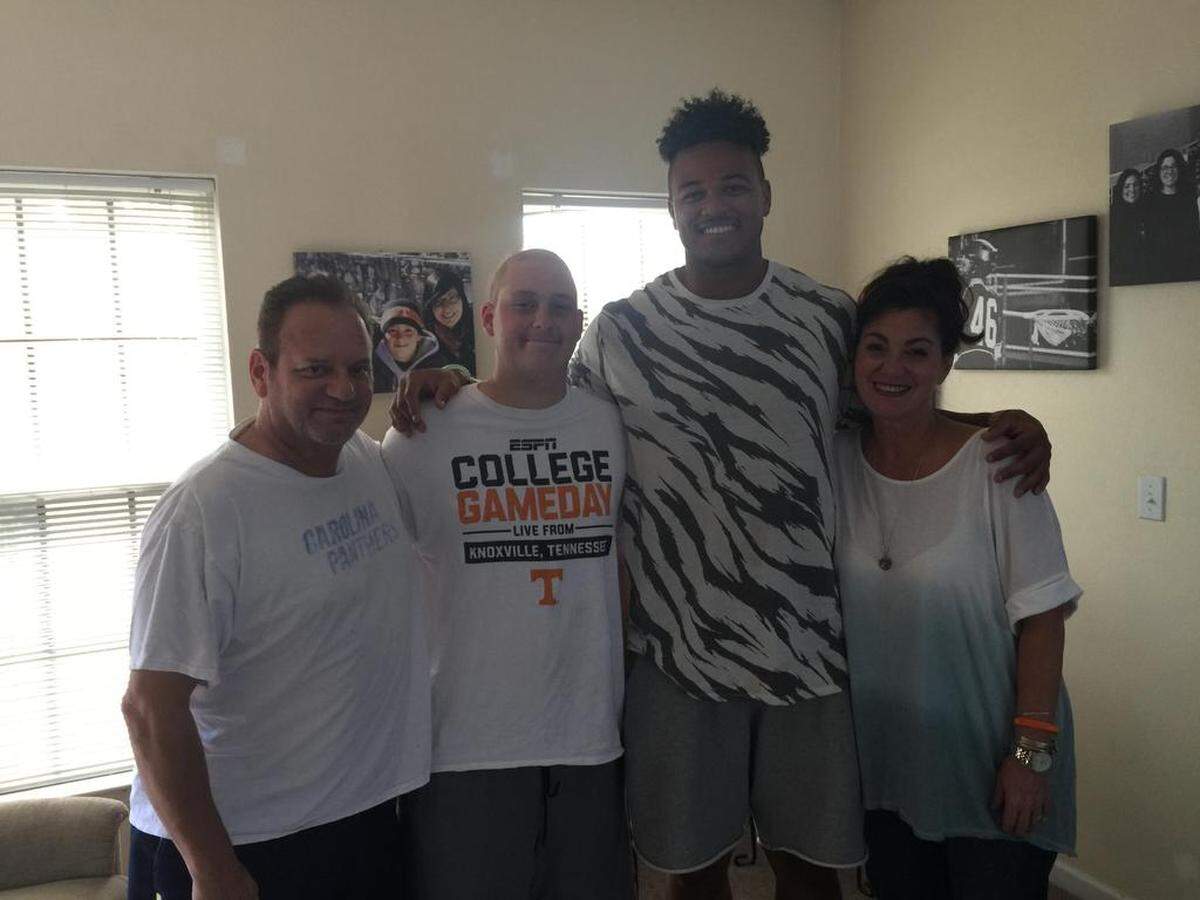 Noah Hays and Carolina Panthers defensive end Wes Horton, center, and Noah's parents, Joe and Gina Cugliari.