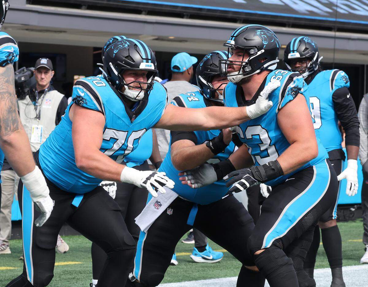Offensive lineman Brady Christensen (70) and Austin Corbett warm up Sunday, Oct. 26, 2025 at Bank of America Stadium in Charlotte