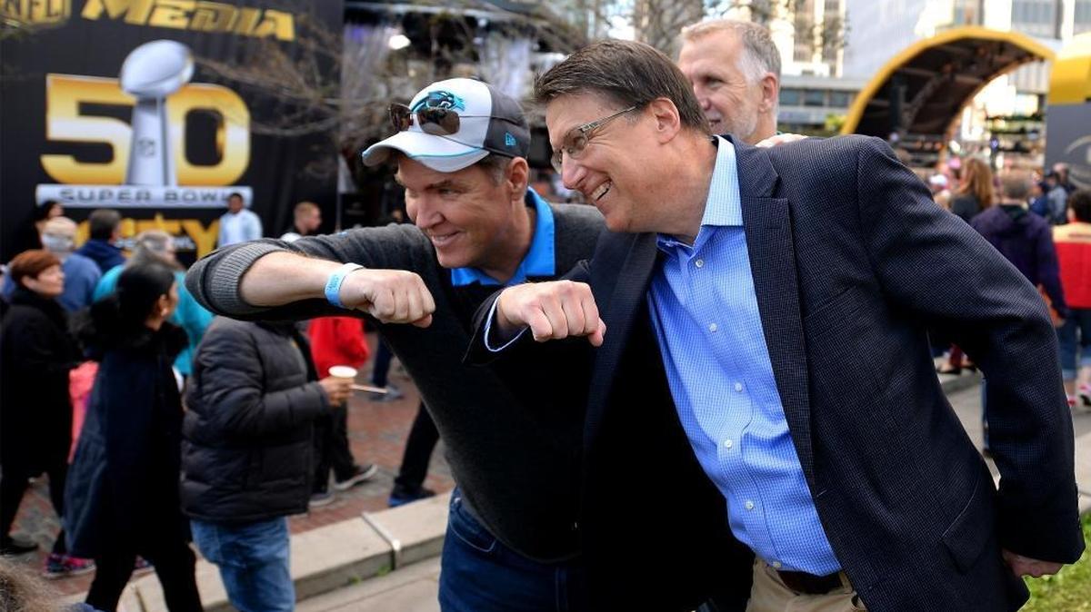 Former secretary of the North Carolina Department of Public Safety Kieran Shanahan, left and NC Governor Pat McCrory, right, dab as NC Sen. Thom Tillis, background looks on in Super Bowl City in San Francisco, CA. on Saturday, February 6, 2016.