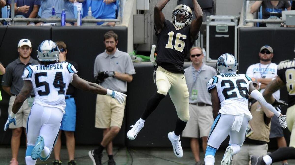 New Orleans Saints wide receiver Brandon Coleman (16) catches a touchdown pass against Carolina Panthers outside linebacker Shaq Thompson (54) and cornerback Daryl Worley (26) in the first half at Bank of America Stadium on Sunday. The Saints won 34-13.