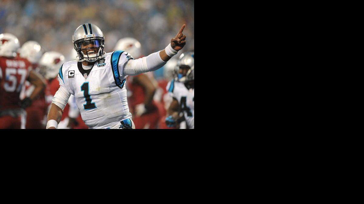 
Carolina Panthers quarterback Cam Newton (1) celebrates a touchdown run by running back Fozzy Whittaker against the Arizona Cardinals, Jan. 3, 2015 in Charlotte. 
