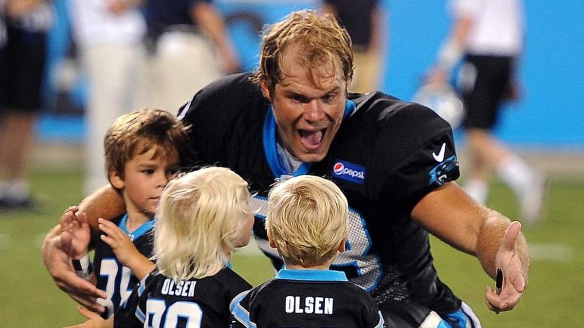 Carolina Panthers tight end Greg Olsen, right, greets son Tate, left, and daughter Talbot, center and son TJ following Fan Fest at Bank of America Stadium on Aug. 7, 2015.