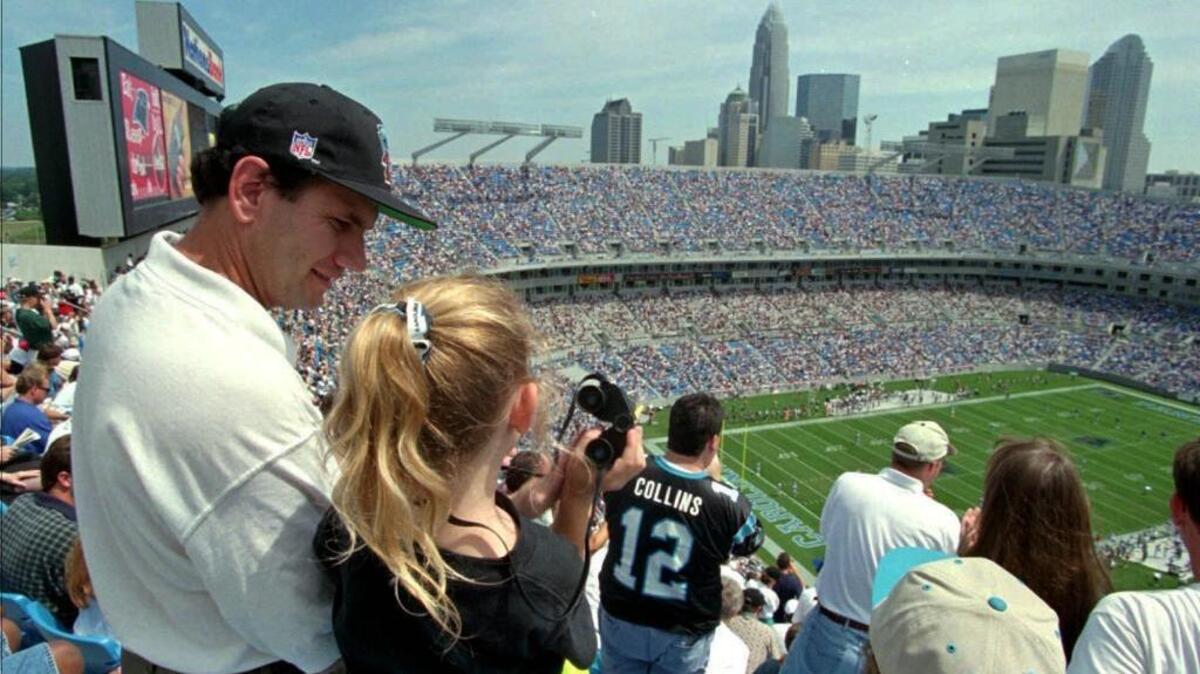 Ron Cobb, left, took his then-6-year-old daughter, Camille, to the first regular-season Panthers game in the uptown stadium in 1996. Now 26, earning her Ph.D. in Seattle, she’s still a die-hard Panthers fan: She hosted a Super Bowl party last year wearing her Cam Newton jersey.