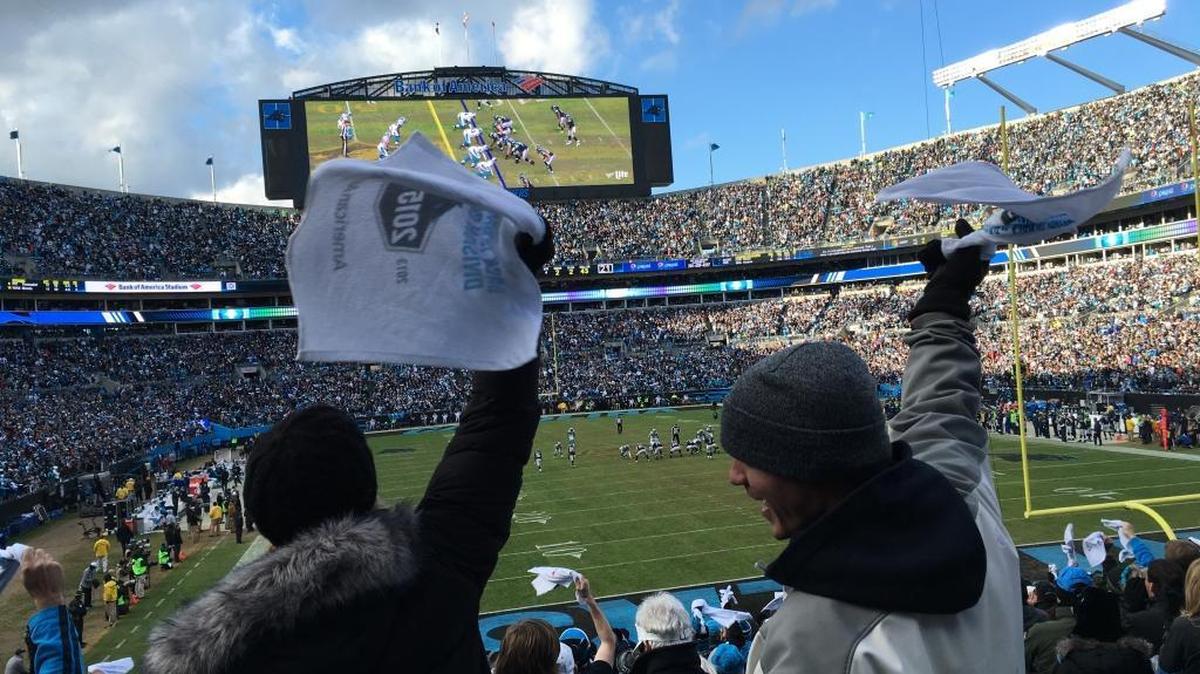 Panthers fans celebrate Sunday as the clock winds down in the fourth quarter of Carolina’s playoff victory.