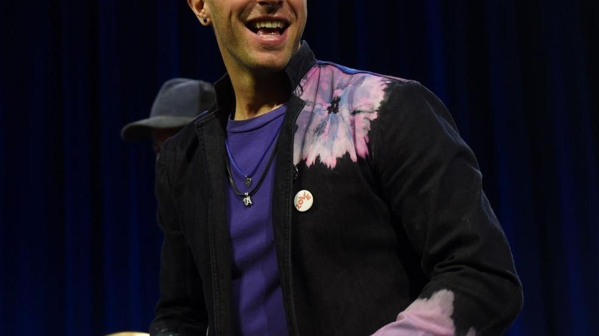 Musician Chris Martin of Coldplay poses with footballs at the Pepsi Super Bowl Halftime Press Conference on February 4, 2016 at the Moscone Convention Center in San Francisco, California.