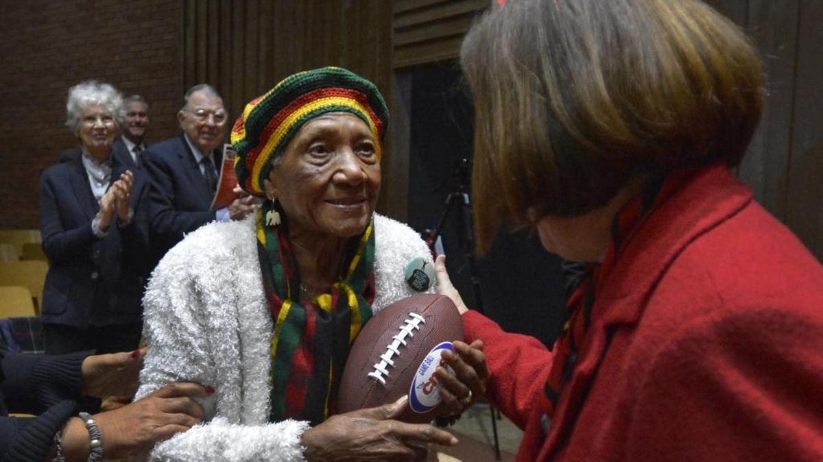 Superintendent Ann Clark presents former Charlotte-Mecklenburg school board member Sarah Stevenson a CMS “game ball” during her annual State of Our Schools speech in January.