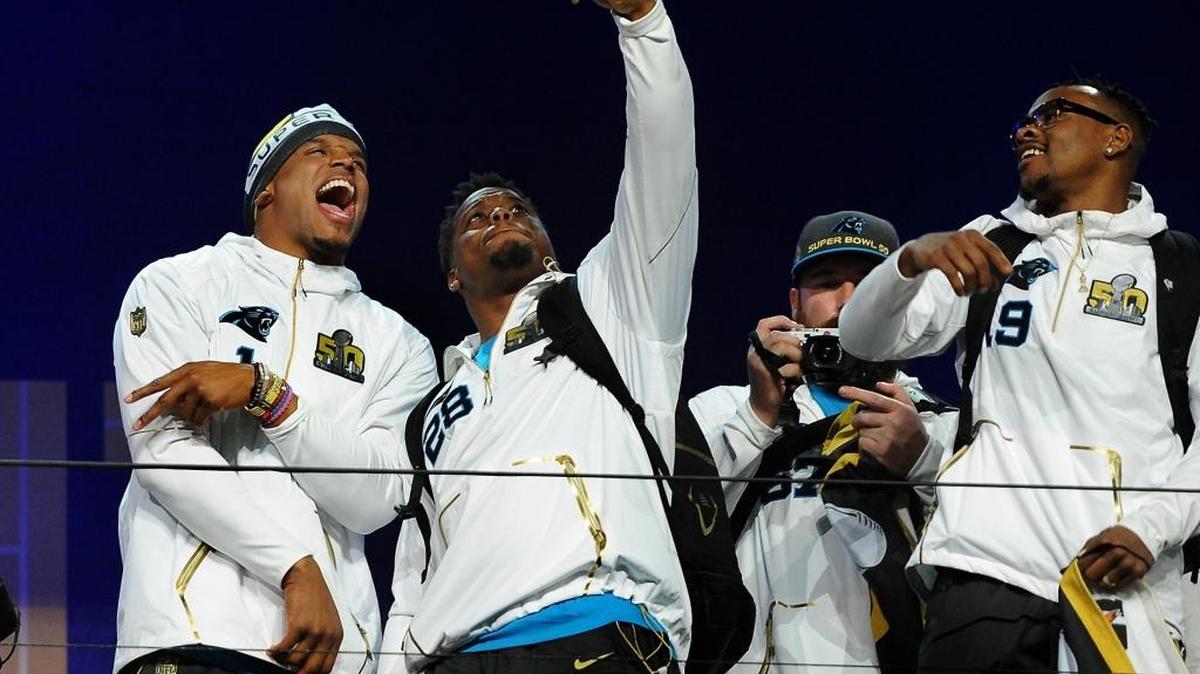 Carolina Panthers quarterback Cam Newton, left and running back Jonathan Stewart, center, joke around while taking a selfie during the Super Bowl Opening Night at SAP Center in San Jose, CA. The Carolina Panthers will face the Denver Broncos in Super Bowl 50 on Sunday, February 7, 2016 in Santa Clara, CA. At right is wide receiver Ted Ginn, Jr.