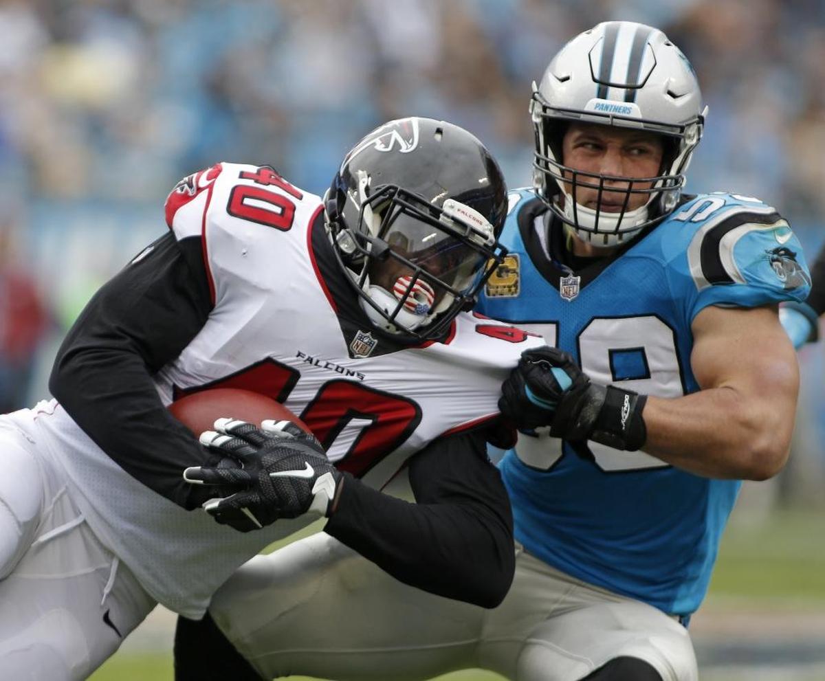 Carolina Panthers' Luke Kuechly (59) tackles Atlanta Falcons' Derrick Coleman (40) in the second half of an NFL football game in Charlotte, N.C., Sunday, Nov. 5, 2017. (AP Photo/Bob Leverone)