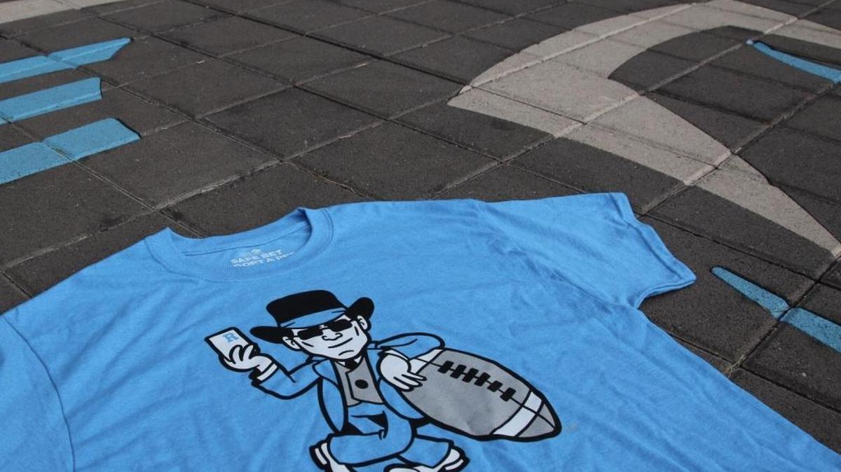 The new “Riverboat Ron” T-shirt is an homage to Panthers head coach Ron Rivera that benefits the Humane Society of Charlotte.