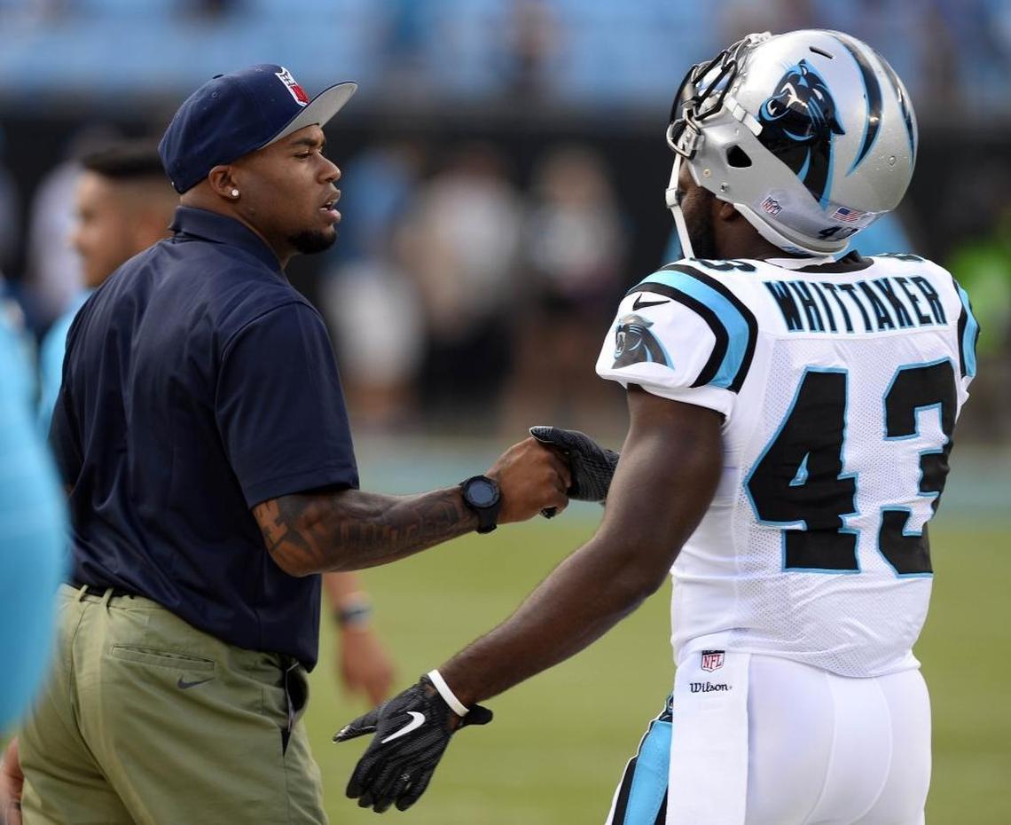 Former Carolina Panthers receiver Steve Smith shakes hands with running back Fozzy Whittaker (43) during warmups prior to playing the Houston Texans in their preseason game at Bank of America Stadium on Wednesday, August 9, 2017. The Panthers led 17-10 at halftime.