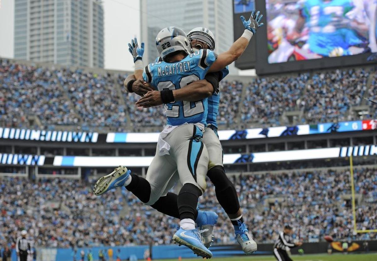 Carolina Panthers' Christian McCaffrey (22) celebrates with Cam Newton after his touchdown run against the Atlanta Falcons in the first half of an NFL football game in Charlotte, N.C., Sunday, Nov. 5, 2017. (AP Photo/Mike McCarn)