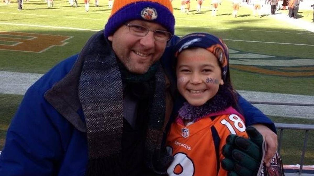 Todd Harwood and his daughter, Isabella, 11, visit Mile High Stadium during the Christmas holiday a few years ago.