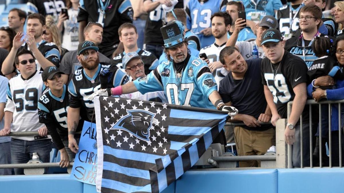 Carolina Panthers fans cheer their team as they walk off the field after defeating the Atlanta Falcons at Bank of America Stadium on Dec. 13, 2015. The Panthers won, 38-0.