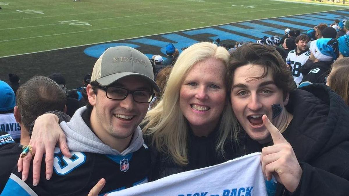 Hillary Cooper (center), director of advancement and communications for The Mint Museum, celebrates a Panthers win.