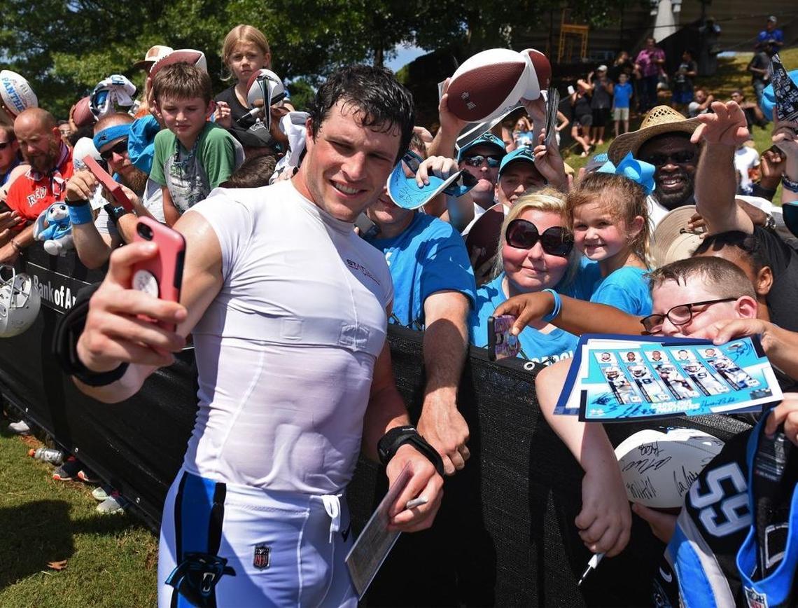 Carolina Panthers linebacker Luke Kuechly obliges a fan's request to takes a photo with fans following practice Saturday at Wofford College in Spartanburg, SC.