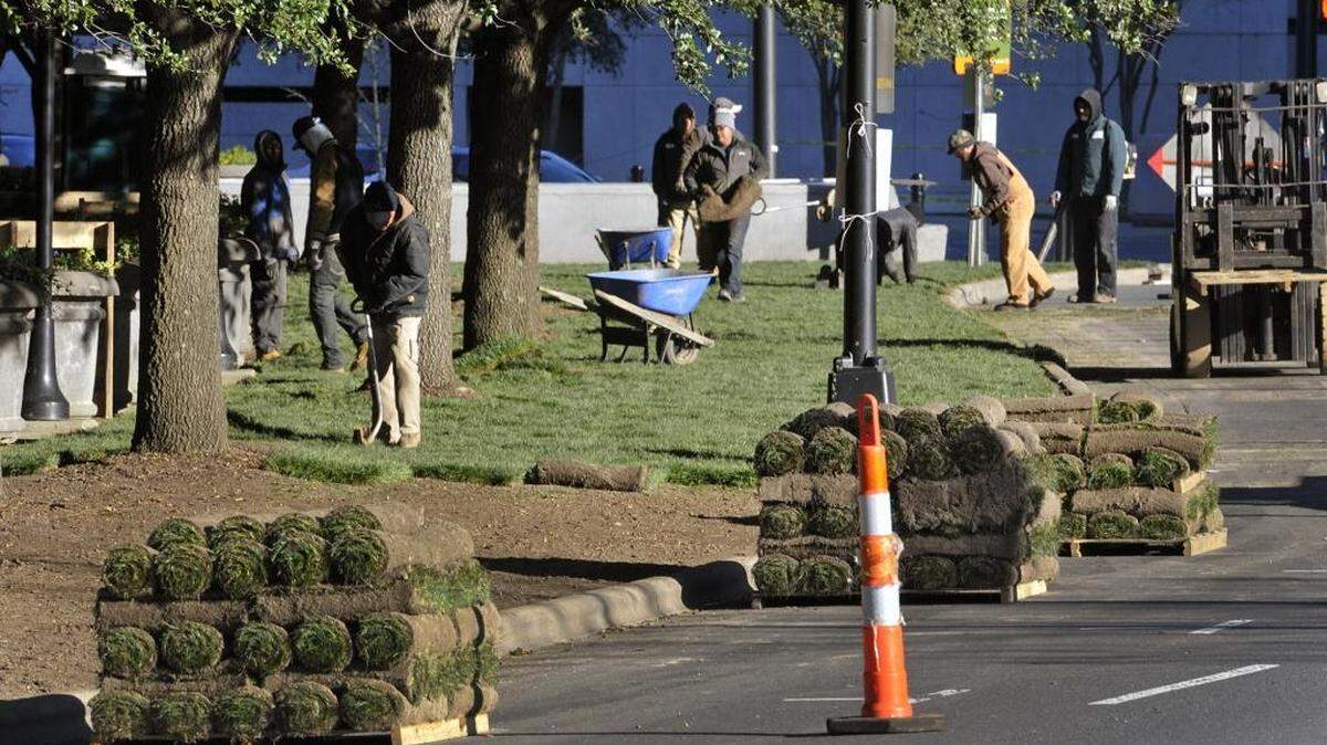 Workers install new sod around the outside of Bank of America Stadium on Monday. The Panthers will host the divisional-round game at the stadium on Jan. 17. The middle of the field is getting fresh sod as well.