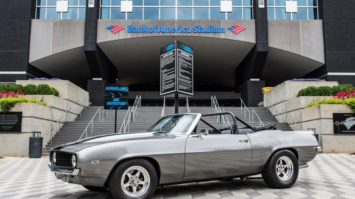 The 1969 Chevrolet Camaro Convertible Greg Olsen is auctioning off. Photo taken in front of Bank of America Stadium