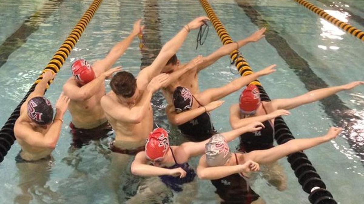 Members of the South Meck High swim team pay homage to the Carolina Panthers by dabbing