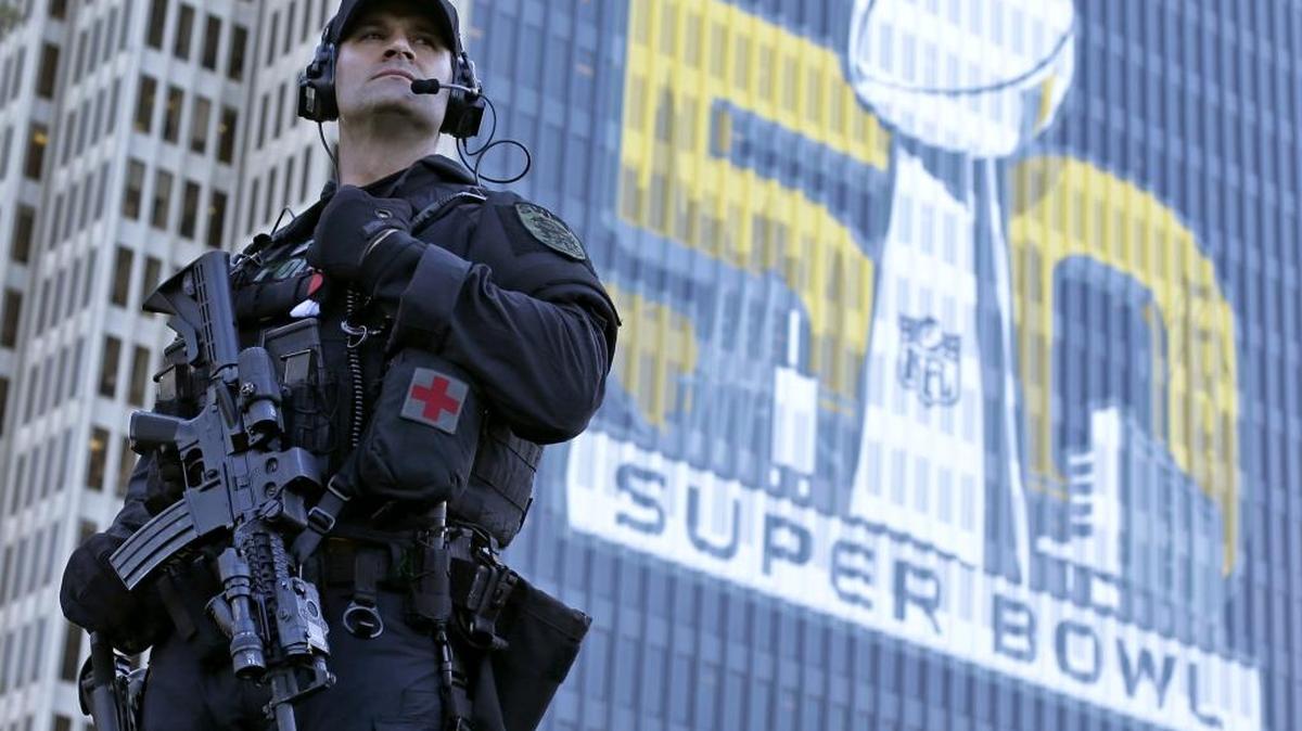 San Francisco Police tactical unit officer Jeff McHale watches the crowd at Super Bowl City Tuesday, Feb. 2, 2016 in San Francisco. From ticket scalpers to terrorism, football's biggest game always presents challenges large and small for law enforcement officials. Their task is made more difficult by the location of Super Bowl 50, some 45 miles from downtown San Francisco, and a number of events throughout the sprawling Bay Area in the run up to the game in Santa Clara on Sunday. (AP Photo/Charlie Riedel)