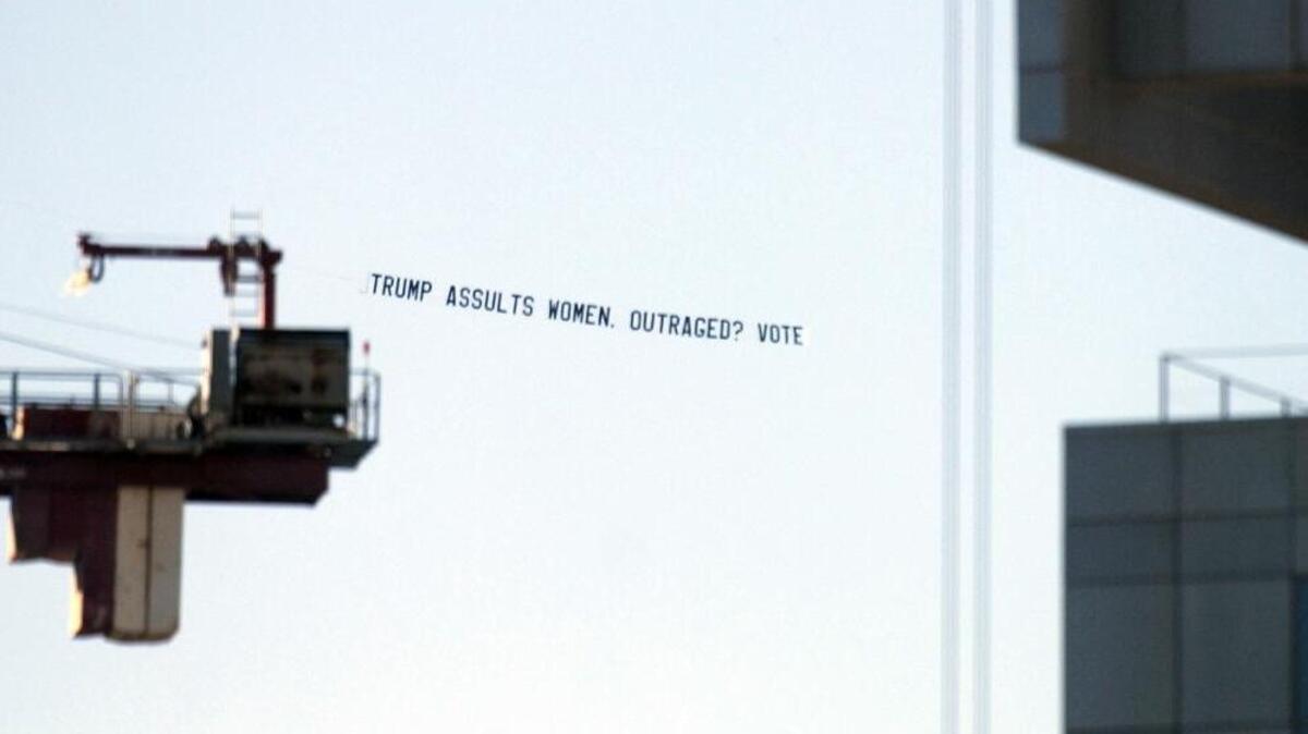A plane tows a banner advertisement over uptown Charlotte Monday, Oct. 10, 2016. UltraViolet Action, a national women’s advocacy organization, commissioned the plane to fly over Bank of America Stadium before the Charlotte Panthers game.