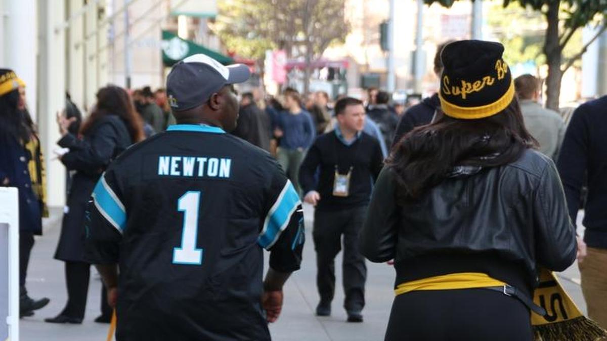 A Carolina Panthers fan – one of just a few spotted Wednesday morning – walks along Howard Street in downtown San Francisco.