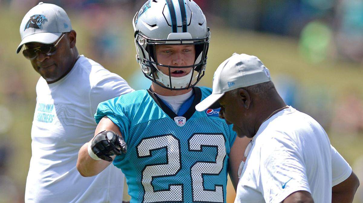 Carolina Panthers running back Christian McCaffrey, center, talks with running backs coach Jim Sklipper, right, during the team’s second training camp practice on Friday, July 27, 2018. The Panthers are holding training camp at Wofford College in Spartanburg, SC.