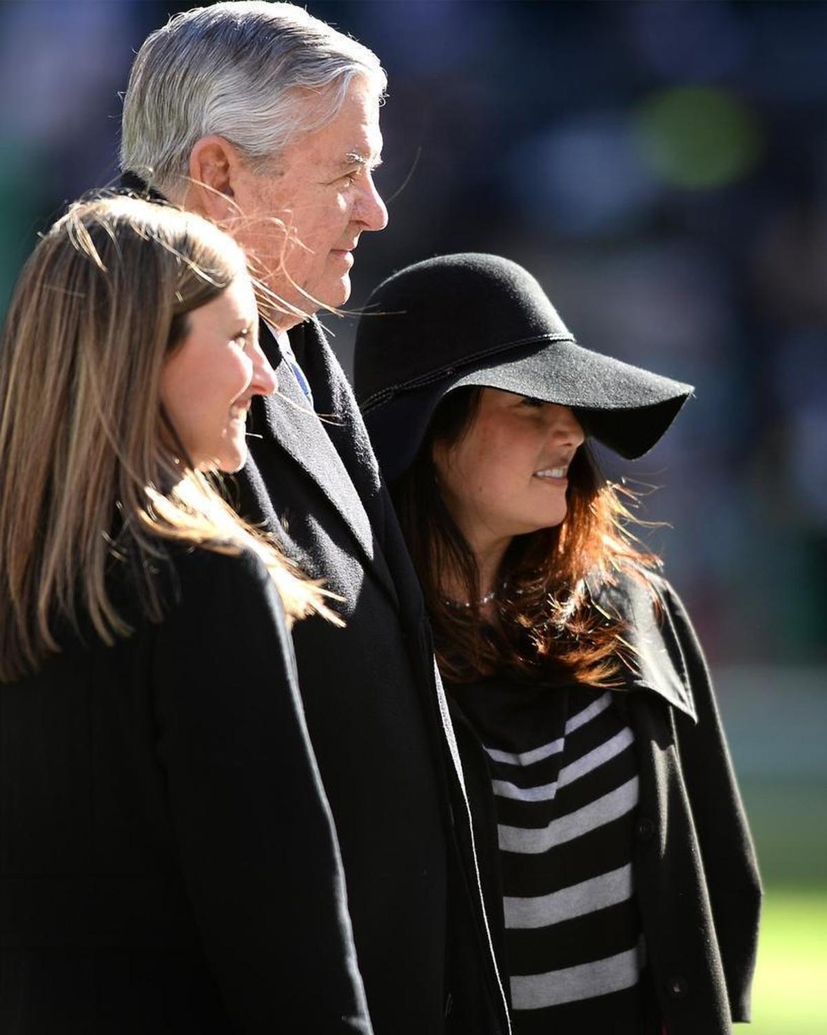 Tina Becker, right, poses for a photograph with Carolina Panthers owner Jerry Richardson, center, along the sidelines at MetLife Stadium on November 26, 2017. Becker is quoted on the Panthers website: “I wouldn’t be here today running an NFL team if not for him.”
