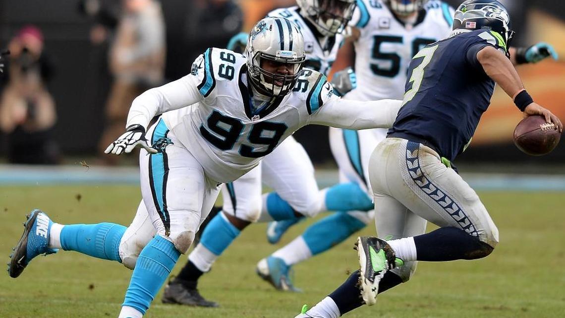 Carolina Panthers defensive tackle Kawann Short, left, chases Seattle Seahawks quarterback Russell Wilson, right, out of the pocket during an NFC playoff game on Jan. 17 in Charlotte.