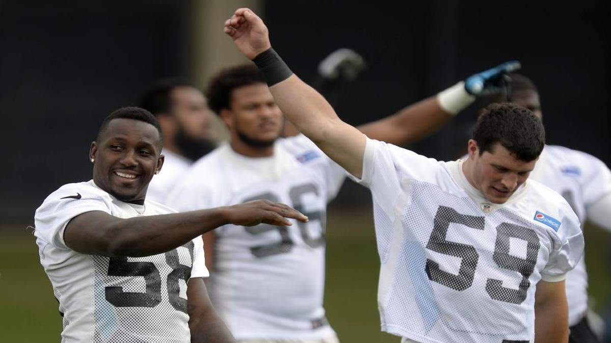 
Carolina Panthers linebackers Thomas Davis (58) and Luke Kuechly (59) stretch during warmups at Panthers OTA practice on Monday. Davis will miss Tuesday’s practice to attend his son’s elementary school graduation.
