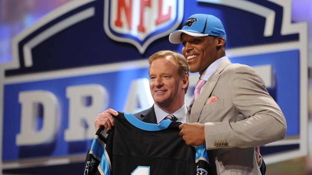 Taking quarterback Cam Newton (right, with NFL commissioner Roger Goodell) was just one of Marty Hurney’s first-round successes in the NFL draft in his first stint with the team. The rest of his drafts showed mixed results.