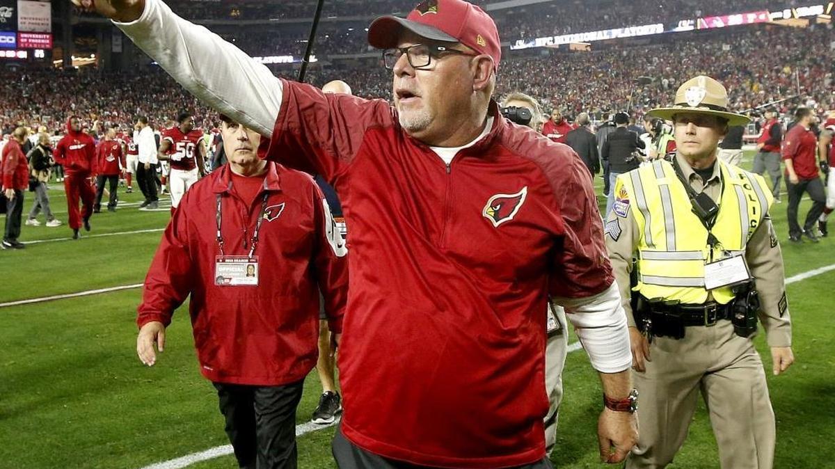 Arizona Cardinals coach Bruce Arians salutes the crowd after Saturday’s 26-20 overtime victory over the Green Bay Packers.