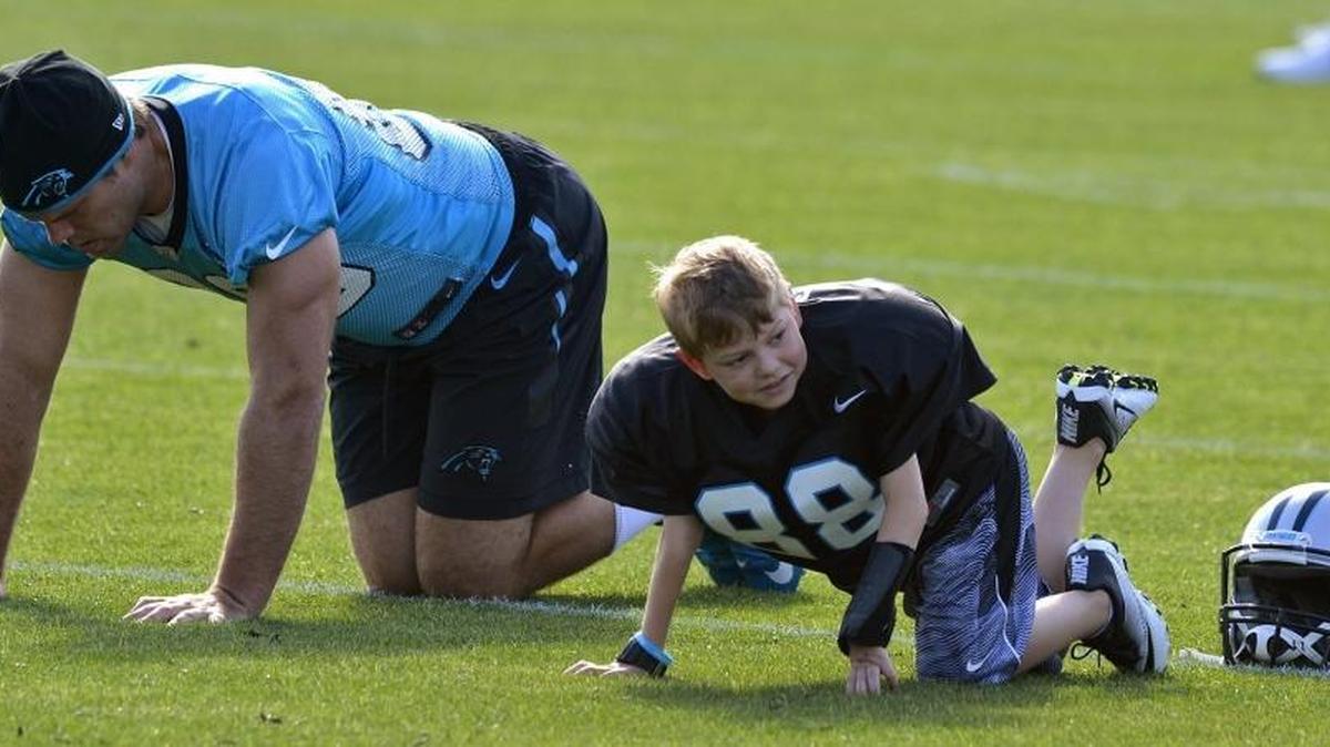 Parker Cowherd, a 7-year-old from Cornelius, got to practice with his favorite Panther, Greg Olsen, thanks to the Make-A-Wish Foundation, during Panthers OTA practice, Tuesday, May 31, 2016.