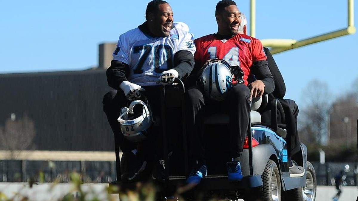 Carolina Panthers guard Trai Turner, left, and quarterback Joe Webb are driven to the team’s practice on owner Jerry Richardson’s club car on Thursday.