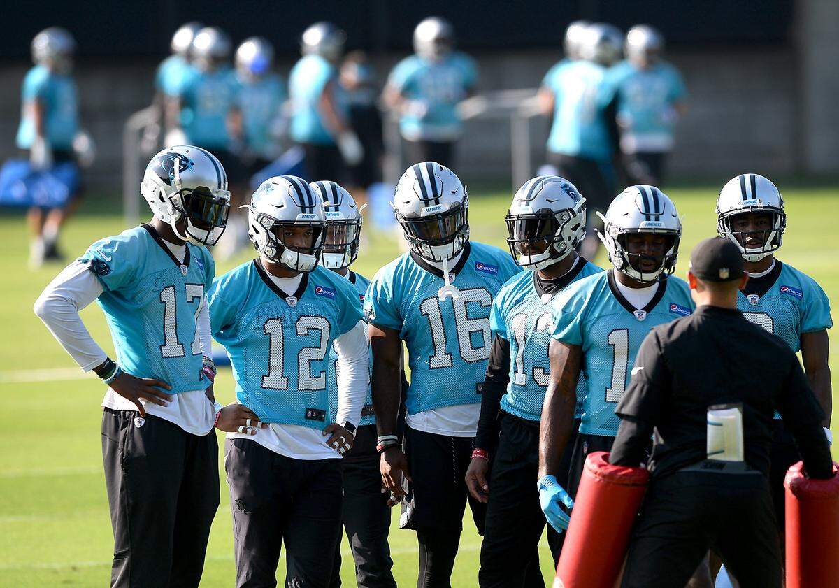 Carolina Panthers wide receiver Rasheed Bailey, center, receives instructions from a coach with other receivers during a team OTA practice on Thursday, June 14, 2018.