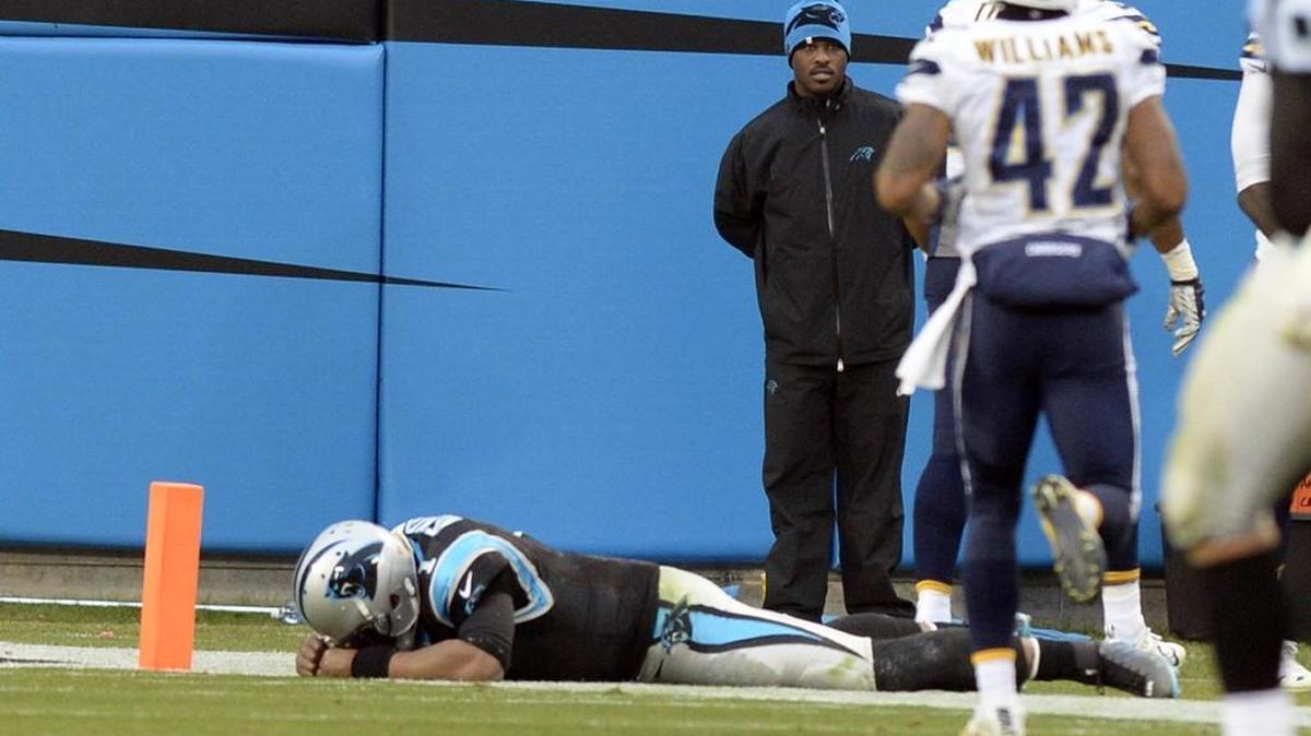 Carolina Panthers quarterback Cam Newton remains on the field after trying to prevent a San Diego Chargers touchdown after an interception in the fourth quarter at Bank of America Stadium last December. It has been reported that it was on this play that Newton suffered a partially torn rotator cuff.