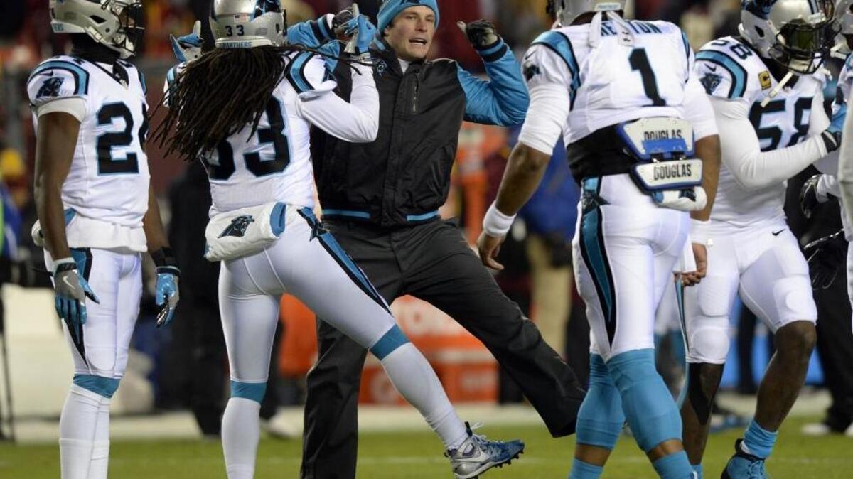Carolina Panthers middle linebacker Luke Kuechly works to get his teammates hyped during warmups before Monday night’s game against Washington. Kuechly was inactive for the game.