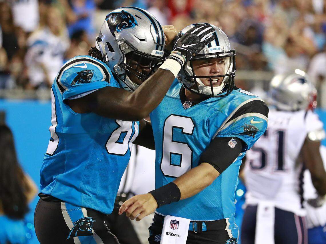 Carolina Panthers backup quarterback Taylor Heinicke (6) is congratulated by receiver Ian Thomas (80) after a touchdown run against the New England Patriots during the second half of Friday's NFL preseason game at Bank of America Stadium.