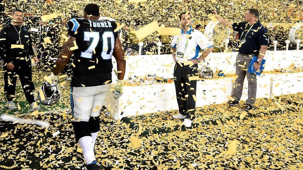 Carolina Panthers guard Trai Turner walks through the falling confetti at Levi’s Stadium after the team’s loss to the Denver Broncos 24-10 in Super Bowl 50.
