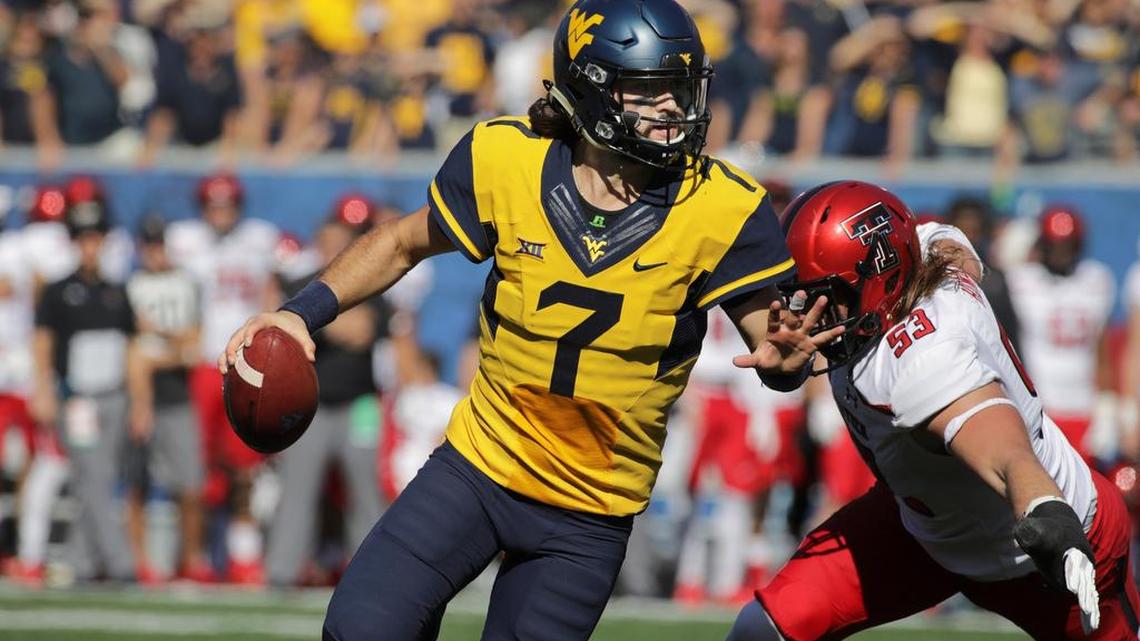 West Virginia quarterback Will Grier (7) scrambles to avoid a Texas Tech defensive lineman Eli Howard (53) during the second half of an NCAA college football game, Saturday, Oct. 14, 2017, in Morgantown, W.Va. West Virginia defeated Texas Tech 46-35. (AP Photo/Raymond Thompson)