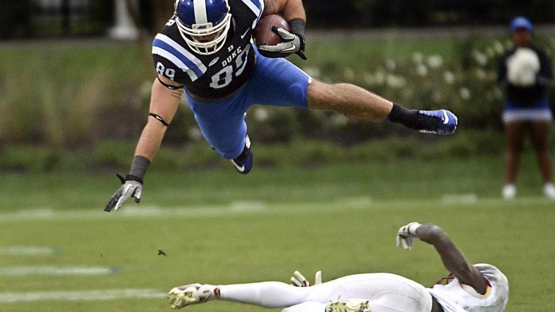 Duke tight end Braxton Deaver (89) leaps over Boston College defensive back Isaac Yiadom (20) for a first down in October.