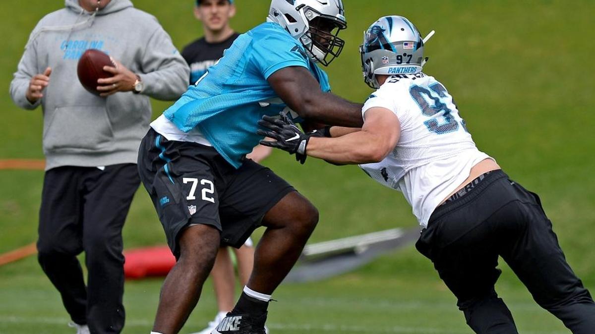 Carolina Panthers rookie tackle Taylor Moton, center/left, battles defensive end Brandon Williams, right, during the team's second session practice of the rookie minicamp on Friday, May 5, 2017. Looking on is head coach Ron Rivera, left.