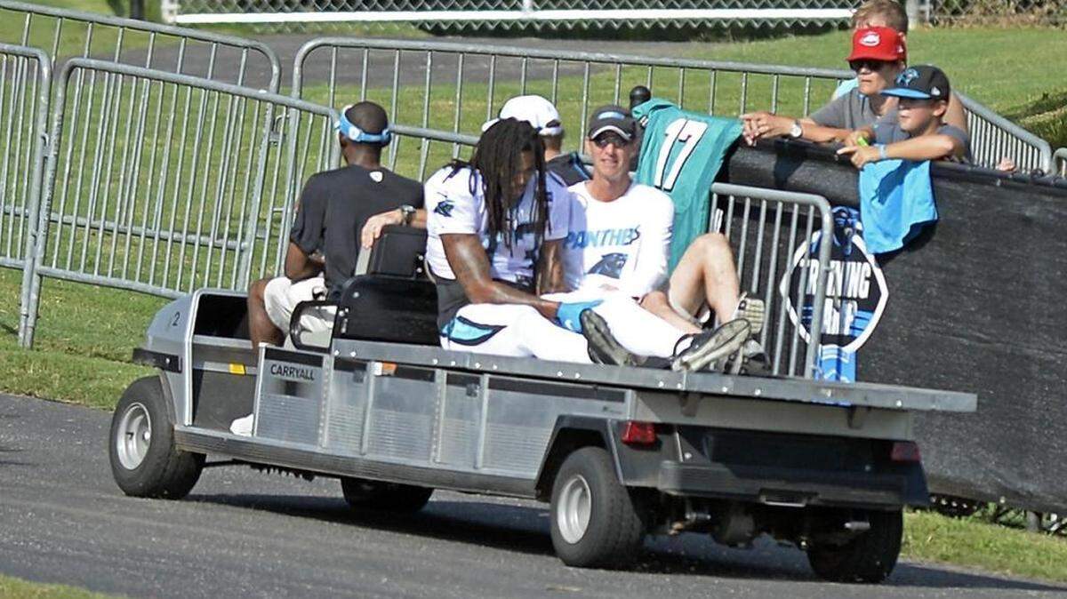 
Carolina Panthers' Kelvin Benjamin (13) holds his leg as he is carted off the field, as head athletic trainer Ryan Vermillion accompanies him, during a scrimmage against the Miami Dolphins during Carolina Panthers Training Camp at Wofford College in Spartanburg, S.C., on Wednesday, Aug. 19, 2015.
