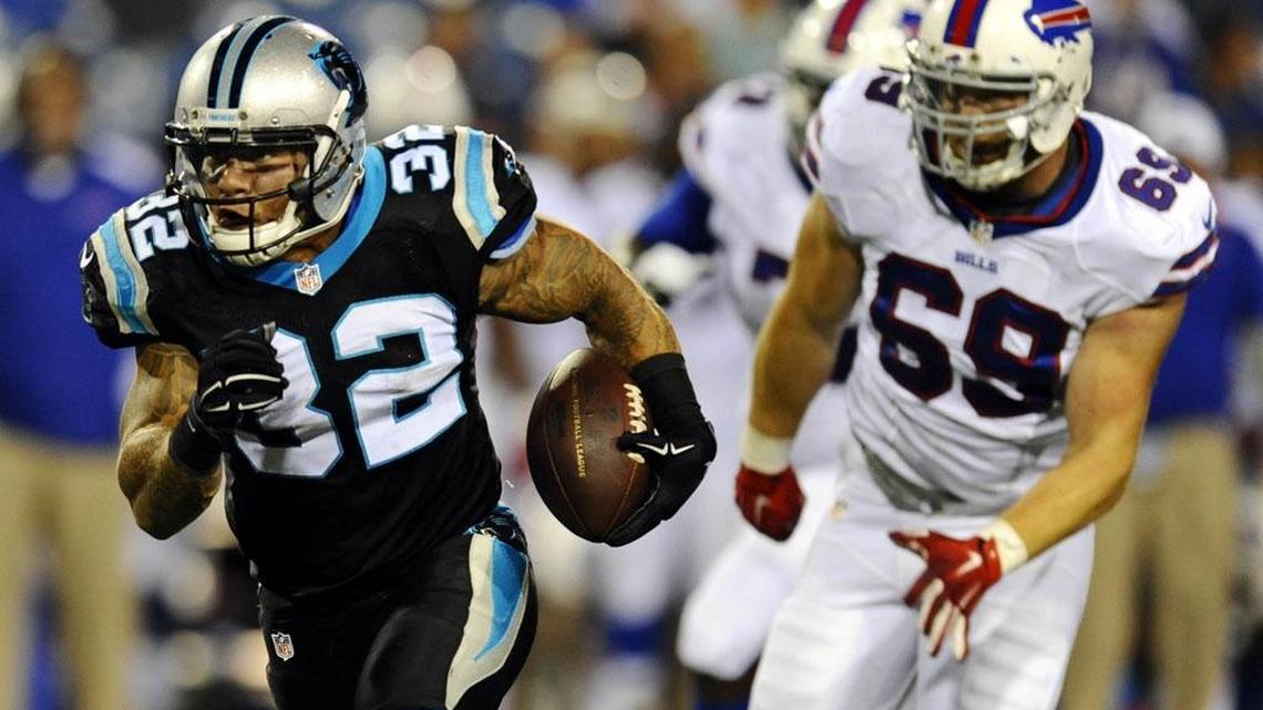 
Carolina Panthers running back Brandon Wegher (32) heads to the end zone for a touchdown as Buffalo Bills' B.J. Larsen (69) pursues in the fourth quarter of the Aug. 14 preseason game at Ralph Wilson Stadium. Carolina won 25-24.
